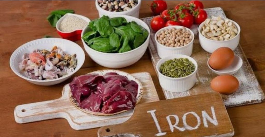 A variety of iron-rich foods such as beef liver, spinach, legumes, eggs, nuts, and seafood to help prevent iron deficiency anemia.